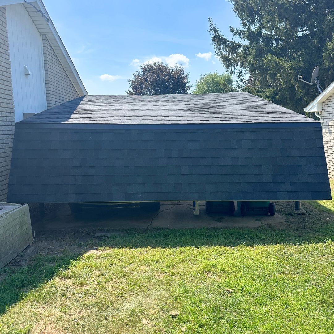 Whimsical carport design with sloping roof near a house in a suburban neighborhood setting.