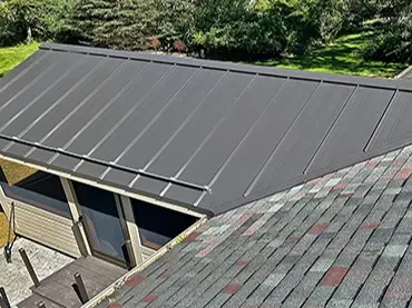 Neighborhood Roofing features modern metal and traditional asphalt shingles in a beautifully landscaped setting.